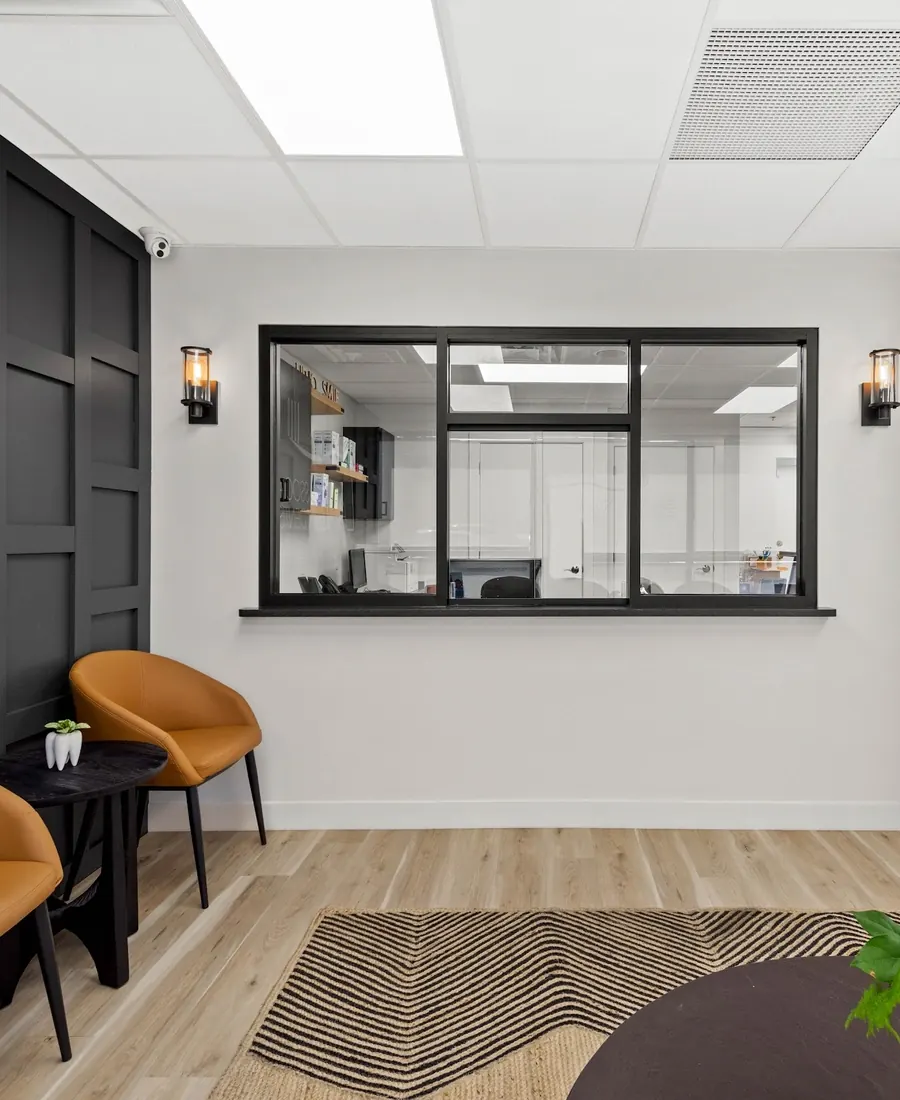 A corner of the Mt. Lebanon waiting room, with the reception window and the Lanz logo wall.